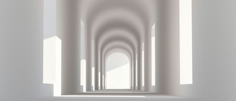 A white arched colonnade in sunlight